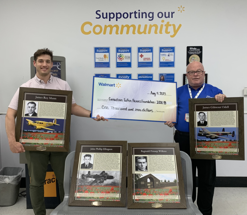 Wetaskiwin Walmart managers hold up memorial prints and donation cheque to the Canadian Fallen Heroes Foundation